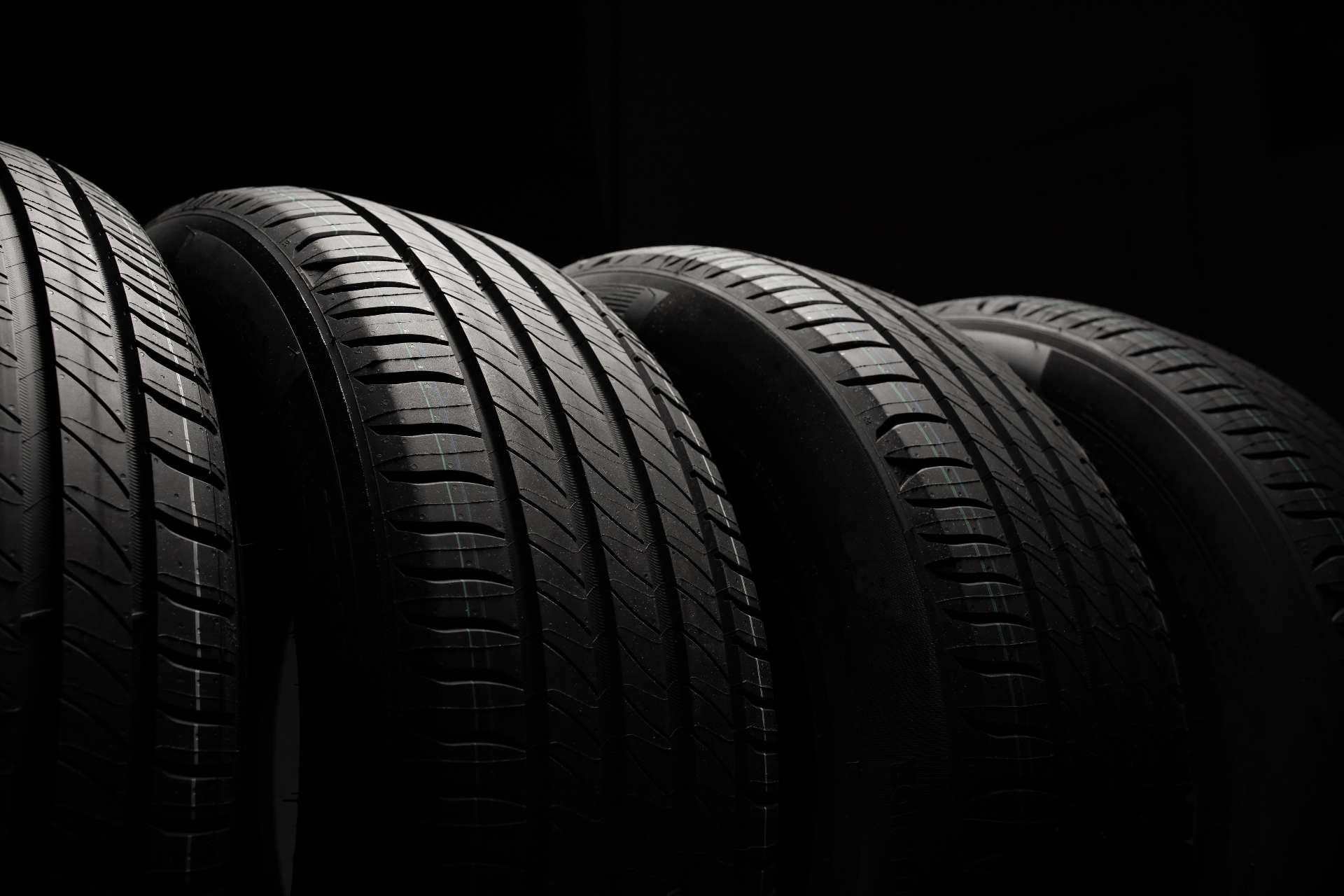 Row of tyres in low-key industrial lighting